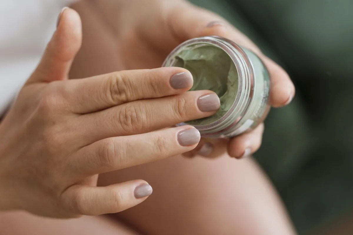 woman-taking-facial-mask-from-container